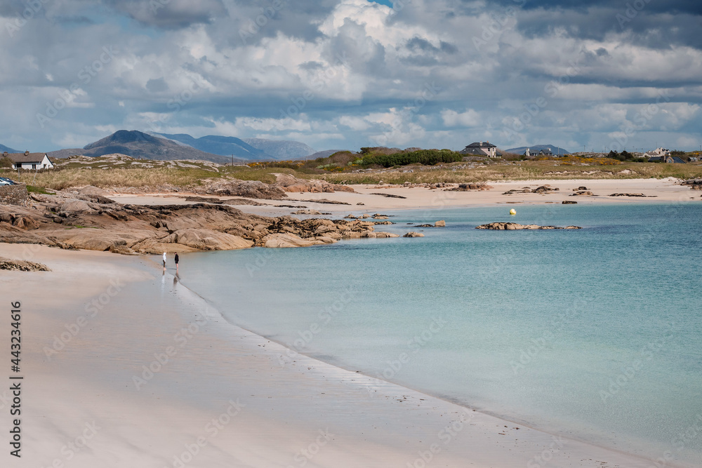 Gurteen bay and beach, near Roundstone town, county Galway, Ireland, warm sunny day, cloudy sky. Beautiful Irish landscape, with clear water and light color sand Gurteen bay and beach, near Roundstone town, county Galway, Ireland, warm sunny day, cloudy sky. Beautiful Irish landscape, with clear water and light color sand