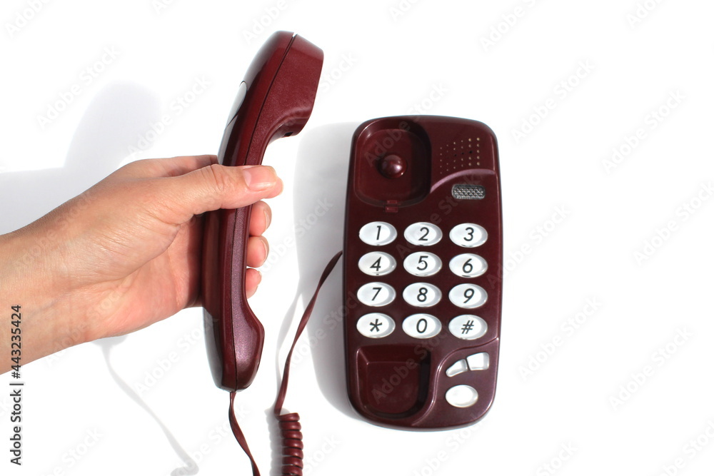 Female hands hold the telephone receiver and press the button Female hands hold the telephone receiver and press the button
