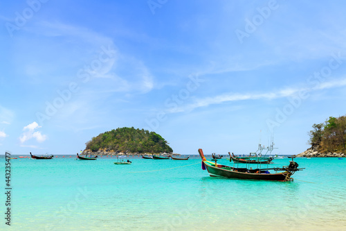 Wooden traditional boat at Kata Beach with crystal clear water, famous tourist destination and resort area, Phuket, Thailand © wirojsid