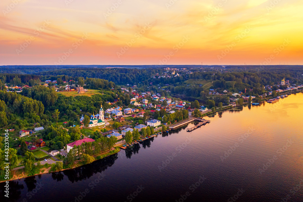 Aerial drone view of ancient russian town Ples on the Volga river with colorful sunset
