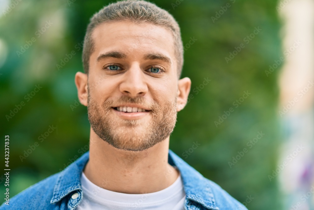 Young caucasian man smiling happy standing at the park. Young caucasian man smiling happy standing at the park.