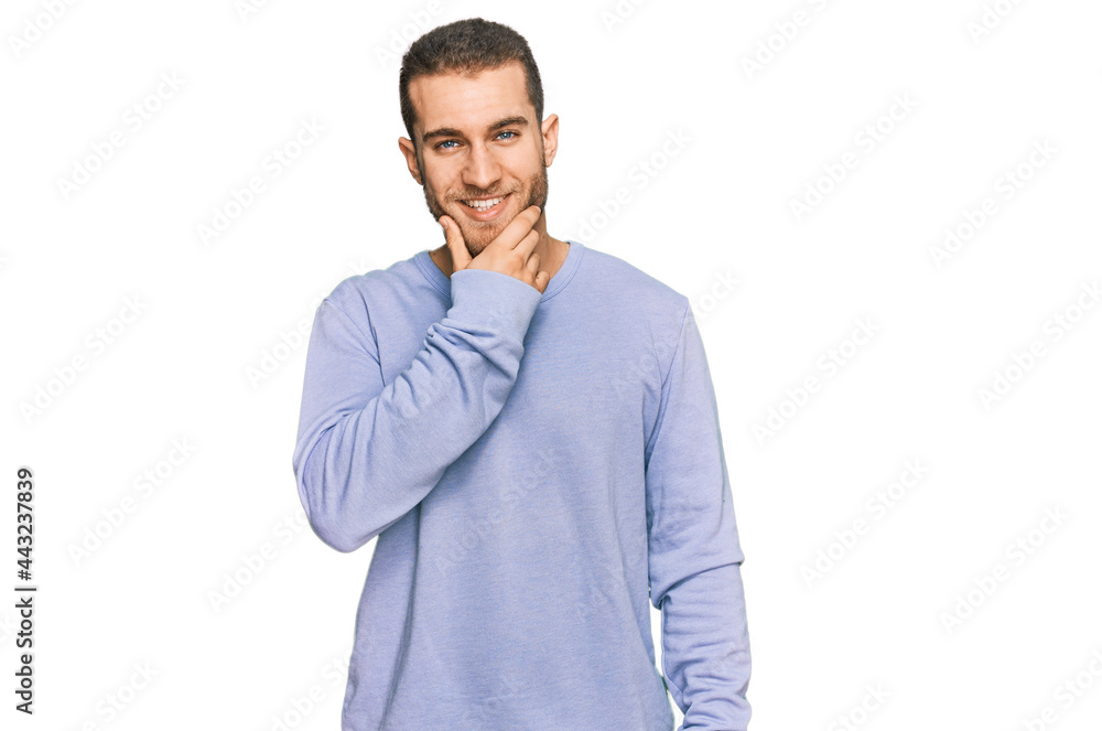 Young caucasian man wearing casual clothes looking confident at the camera smiling with crossed arms and hand raised on chin. thinking positive. Young caucasian man wearing casual clothes looking confident at the camera smiling with crossed arms and hand raised on chin. thinking positive.