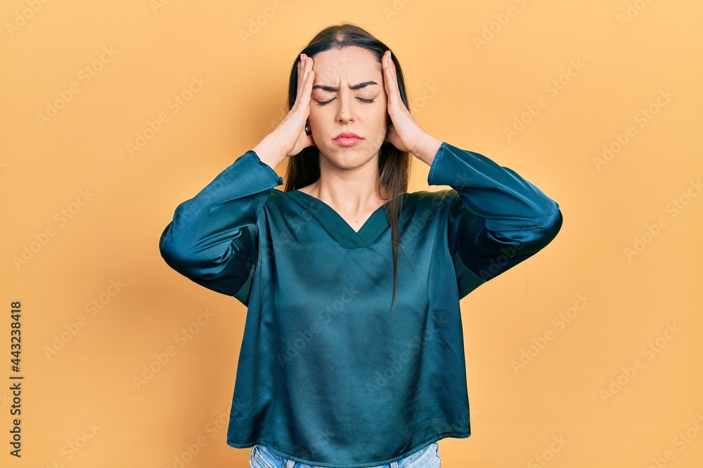 Beautiful woman with blue eyes wearing elegant shirt suffering from headache desperate and stressed because pain and migraine. hands on head. Beautiful woman with blue eyes wearing elegant shirt suffering from headache desperate and stressed because pain and migraine. hands on head.