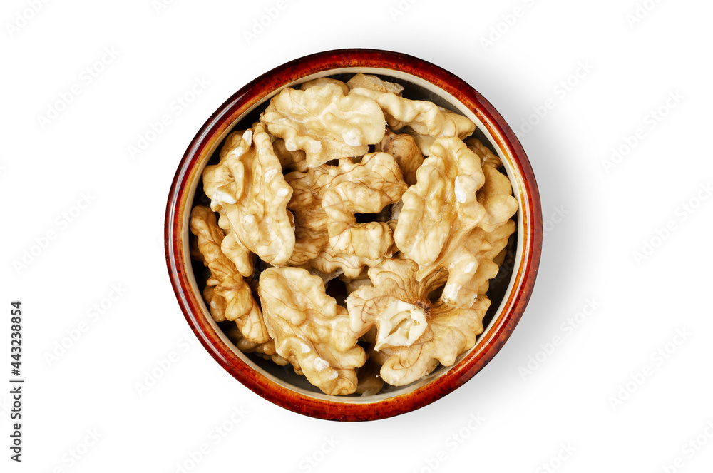 Peeled walnut kernels in a bowl. Isolated on a white background. Nuts contain vegetable protein and vitamins. For a healthy and vegetarian diet