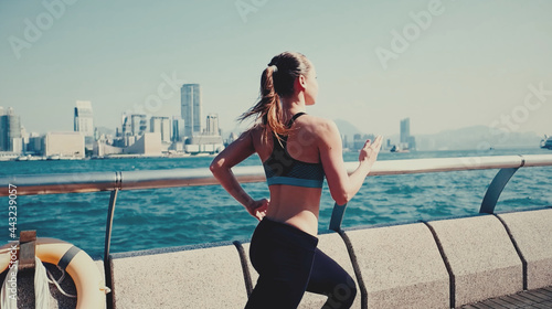 Canvas Print Young, attractive woman jogging in the city.