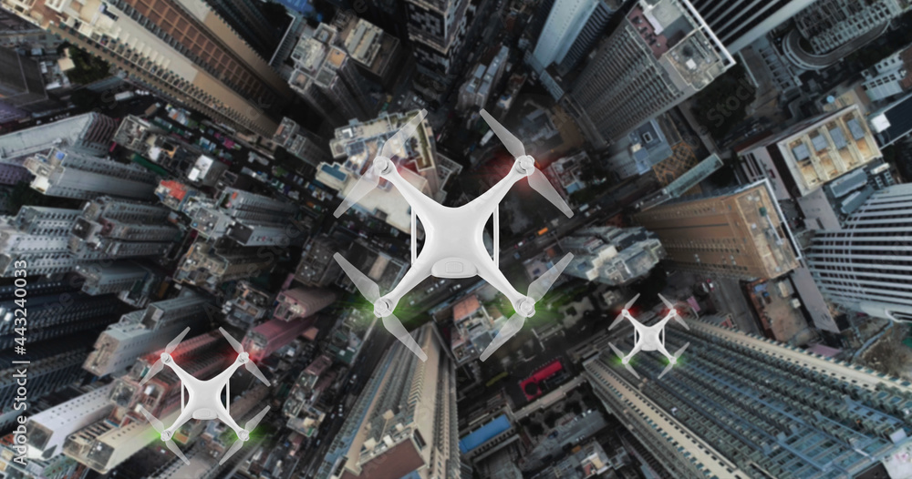 AERIAL. Top view of Group of Drones delivers the goods against the background of Hong Kong city.