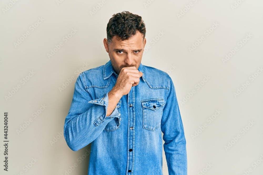 Young hispanic man wearing casual clothes feeling unwell and coughing as symptom for cold or bronchitis. health care concept.