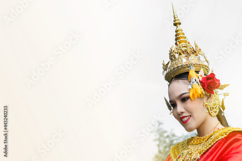 Beautiful Thai girl in traditional dress red dancer costume, identity culture of Thailand. Close up head shot of women wearing thai dress dancing lady. photo