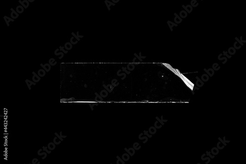 adhesive transparent tape on black background. abstract crumpled sticky tape for poster design element or overlay. photo