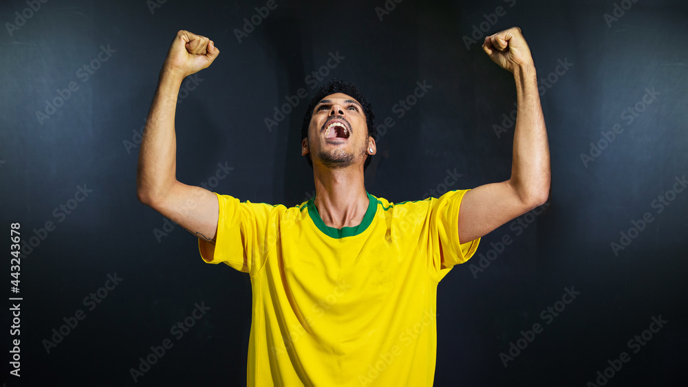 Olympics happy black man fan in uniform isolated on black background. Space for text. Olympics happy black man fan in uniform isolated on black background. Space for text.