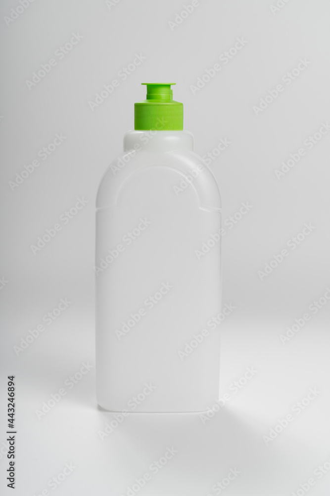 white plastic bottle with a green cork on a white background. recycling plastic. white plastic bottle with a green cork on a white background. recycling plastic.