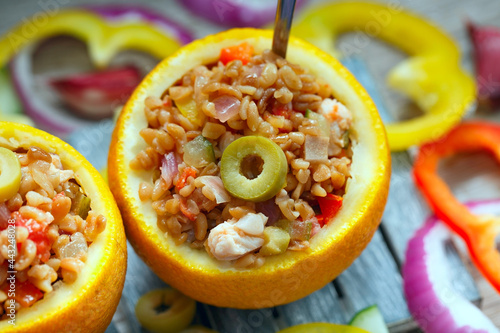 Принти на полотні An exotically decorated dish of bulgur, poultry and vegetables with oranges