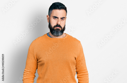 Hispanic man with beard wearing casual winter sweater depressed and worry for distress, crying angry and afraid. sad expression.