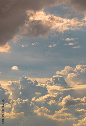 The sun shines through the clouds in the sky. The shape of the clouds evokes imagination and creativity. They can be used as wallpapers that look amazing. Copy space, No focus, specifically. © num