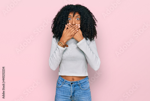 Young african american girl wearing casual clothes shocked covering mouth with hands for mistake. secret concept. © Krakenimages.com