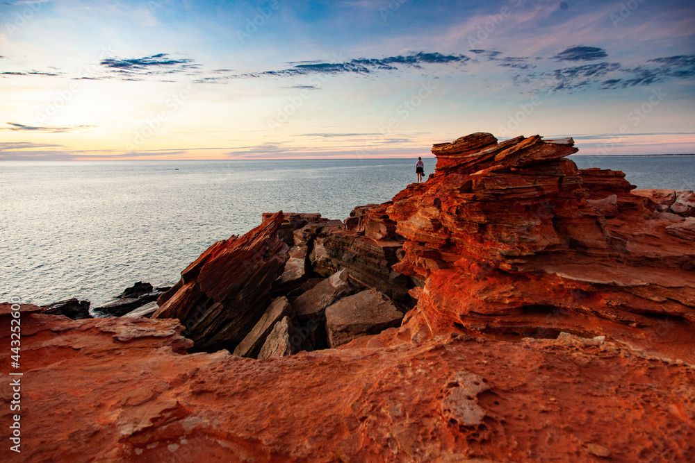 A distant figure looks out across the ocean at Gantheaume Point, Broome. - obrazy, fototapety, plakaty 