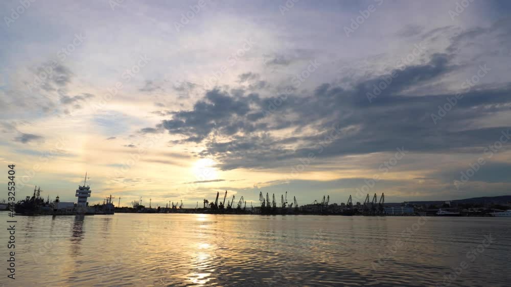moving clouds and boat at sunset over the Sea at Port in Varna, Bulgaria moving clouds and boat at sunset over the Sea at Port in Varna, Bulgaria