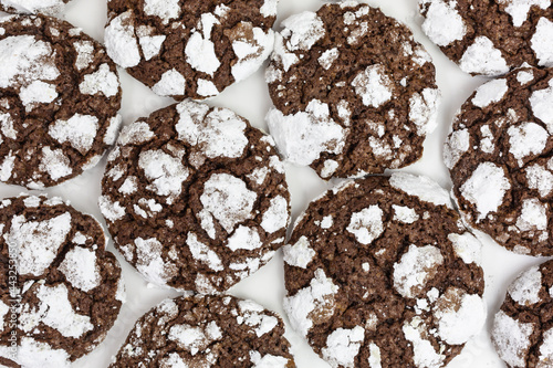 background of chewy crinkle chocolate cookies with confectioners sugar