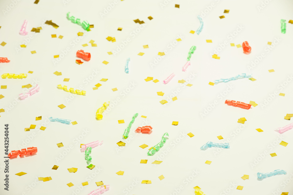 golden confetti and colored spirals on a light background golden confetti and colored spirals on a light background