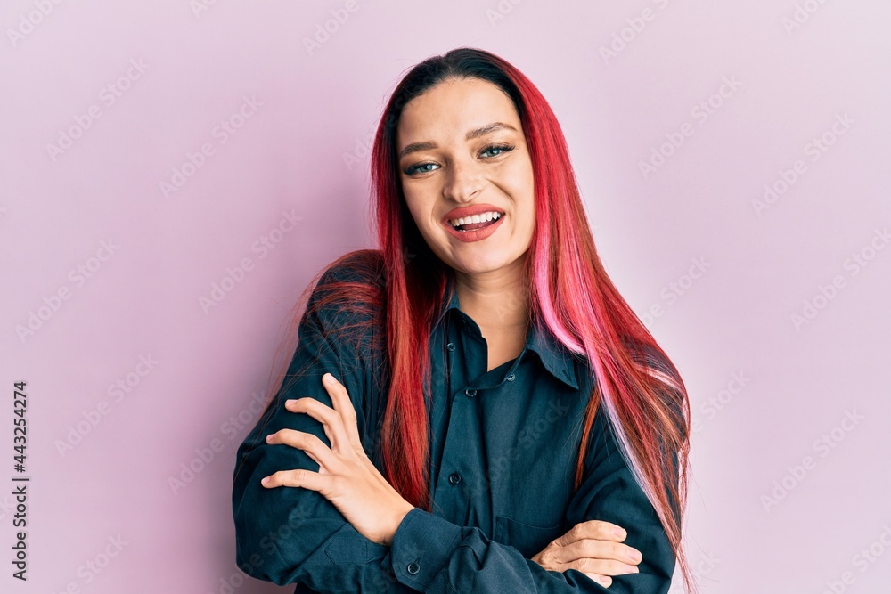 Young caucasian woman wearing casual clothes happy face smiling with crossed arms looking at the camera. positive person. Young caucasian woman wearing casual clothes happy face smiling with crossed arms looking at the camera. positive person.