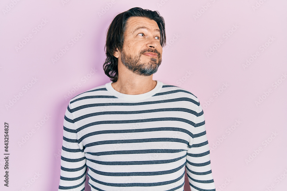 Fototapeta premium Middle age caucasian man wearing casual clothes smiling looking to the side and staring away thinking.