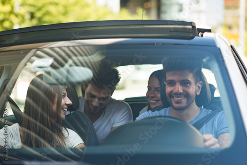 Group of friends on a car photo