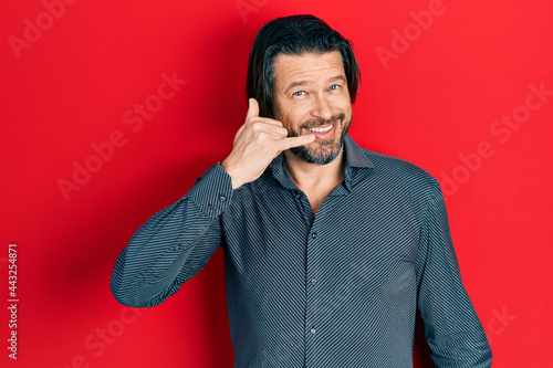 Photography Middle age caucasian man wearing casual clothes smiling doing phone gesture with hand and fingers like talking on the telephone