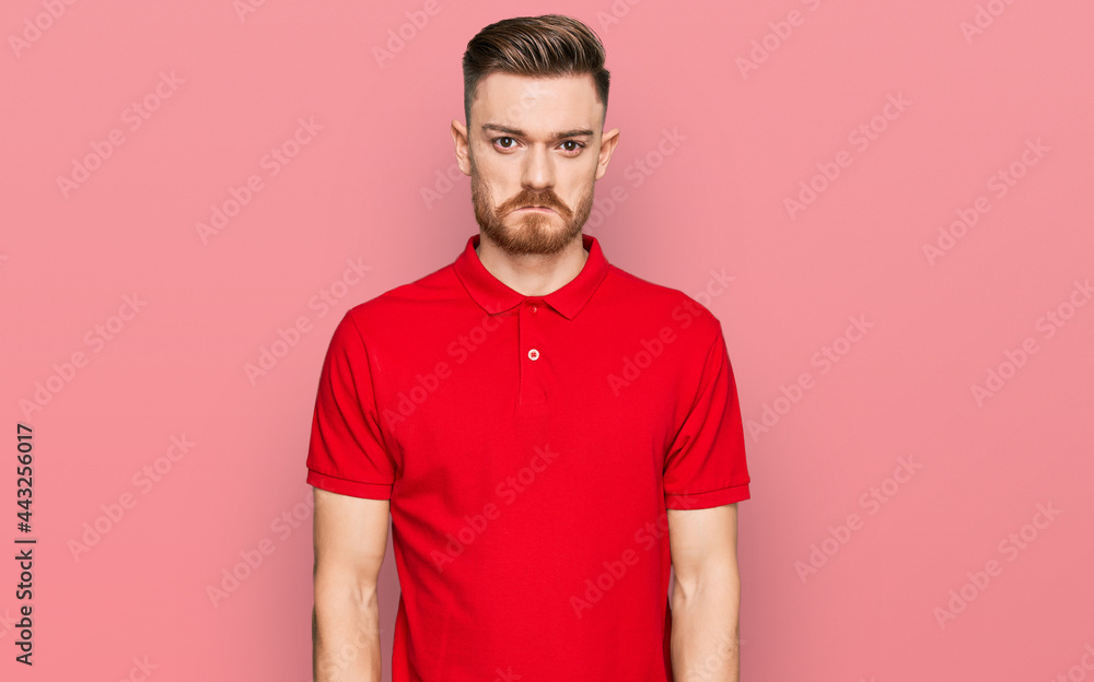 Young redhead man wearing casual clothes depressed and worry for distress, crying angry and afraid. sad expression. Young redhead man wearing casual clothes depressed and worry for distress, crying angry and afraid. sad expression.