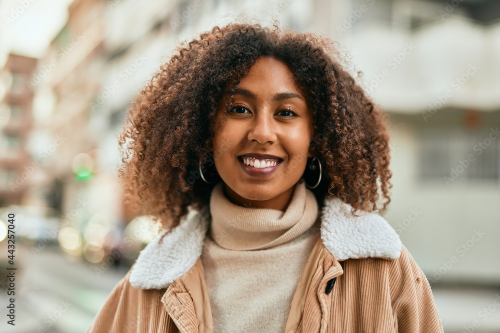 Young african american woman smiling happy standing at the city. Young african american woman smiling happy standing at the city.
