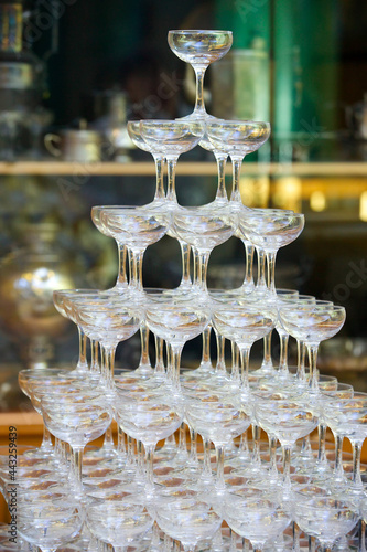 Crystal glasses for holiday, a lot of glasses for guests. Slide pyramid of glasses.