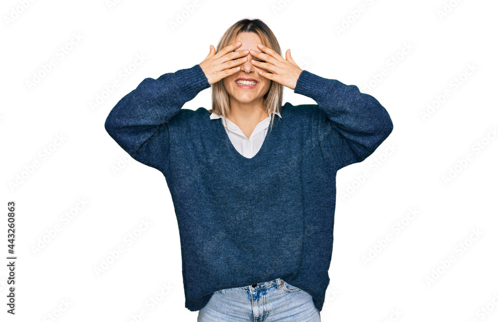 Young caucasian woman wearing casual clothes covering eyes with hands smiling cheerful and funny. blind concept.