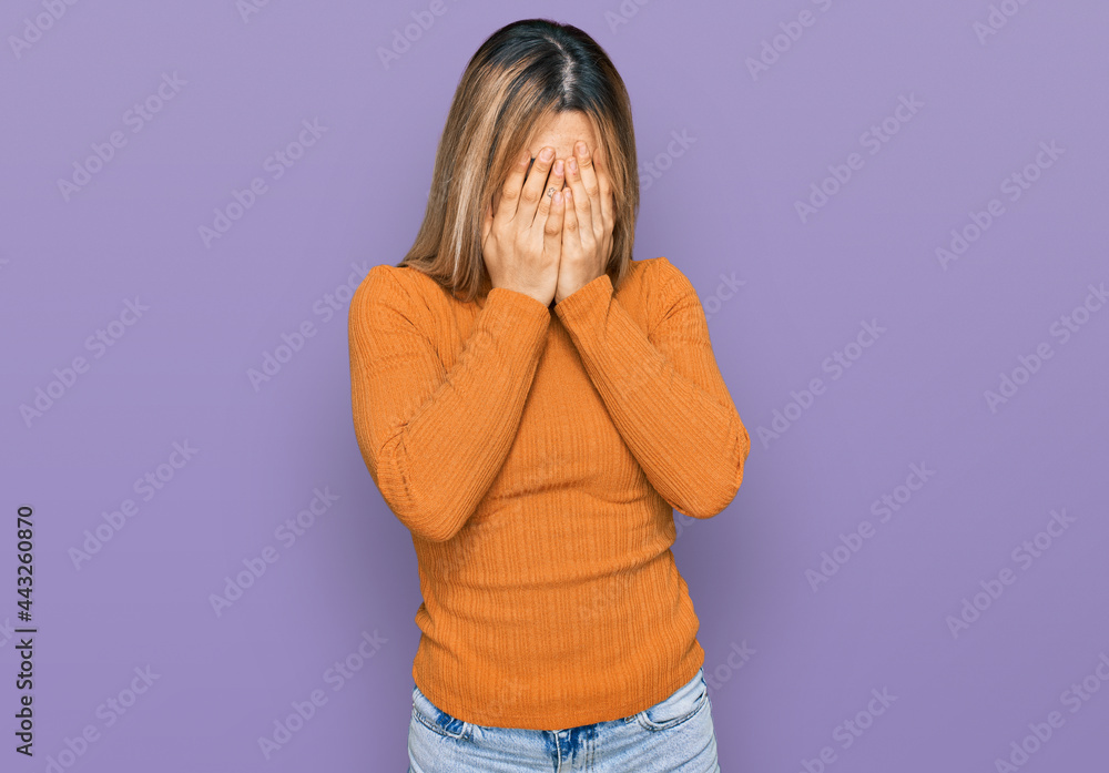 Young caucasian woman wearing casual clothes with sad expression covering face with hands while crying. depression concept. Young caucasian woman wearing casual clothes with sad expression covering face with hands while crying. depression concept.