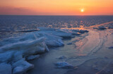 Winter landscape with sunset sky and frozen sea. Daybreak