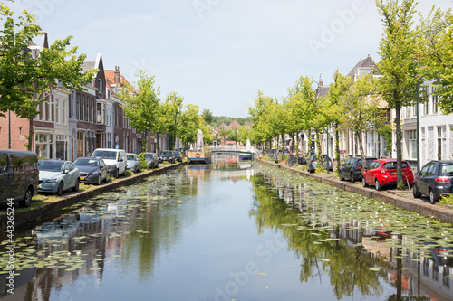 Cityscape of Delft with canal, bikes and historic houses in a summer setting, the Netherlands