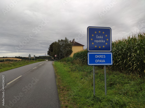 Border road sign informing about entering the Czech Republic on the Polish-Czech border in the Opava district with the road next to it