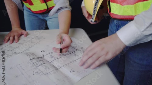 male and female engineers construction plan