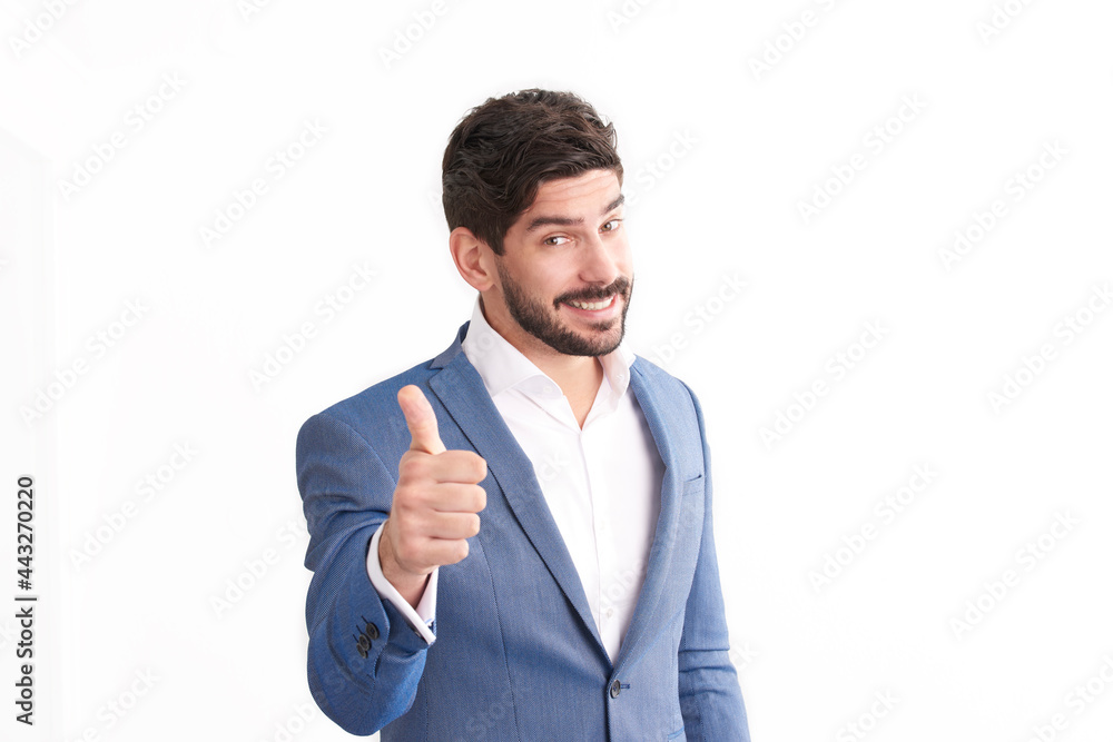 Thumbs up. Portrait of happy businessman in suit giving thumbs up while standing at isolated white background and looking at camera. Thumbs up. Portrait of happy businessman in suit giving thumbs up while standing at isolated white background and looking at camera.