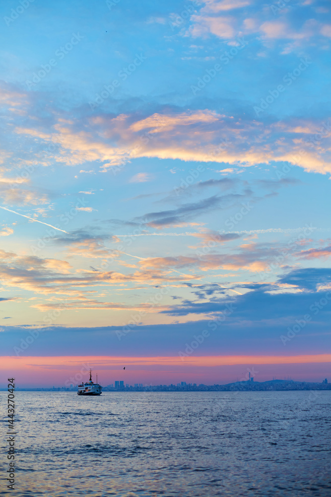 Sunset in the Bosphorus. A ship is sailing in the water Sunset in the Bosphorus. A ship is sailing in the water