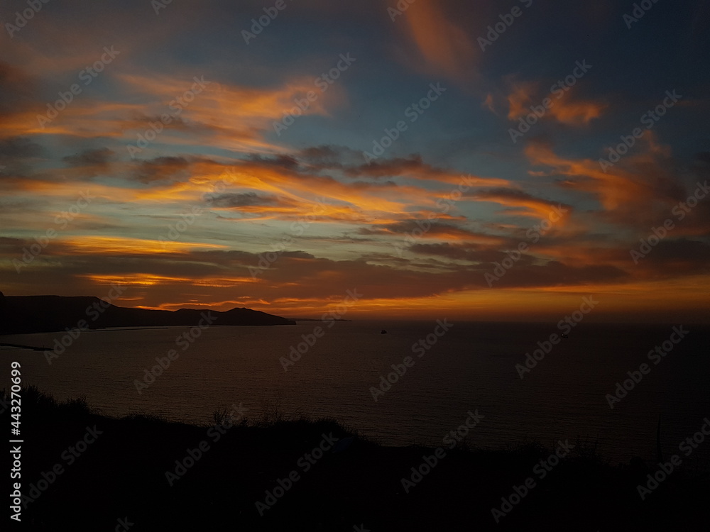 Scenic view of a calm coast during sunset with moutains in the background, Oran Algeria Scenic view of a calm coast during sunset with moutains in the background, Oran Algeria