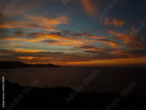 Scenic view of a calm coast during sunset with moutains in the background, Oran Algeria