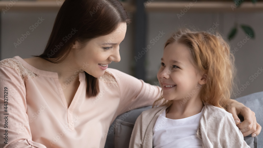Pleasant conversation. Happy preteen girl sit on couch glad to talk to friendly female teacher psychologist answer questions discuss school life. Smiling little daughter ask supportive mom for advice Pleasant conversation. Happy preteen girl sit on couch glad to talk to friendly female teacher psychologist answer questions discuss school life. Smiling little daughter ask supportive mom for advice