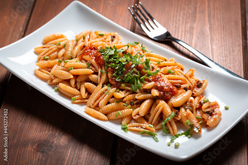 Deliziosi malloreddus conditi con ragu di pesce, pasta tradizionale della Sardegna, Cucina Italiana  photo