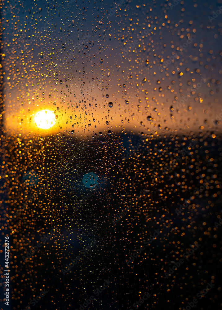sunset through the window with drops of rain on it sunset through the window with drops of rain on it