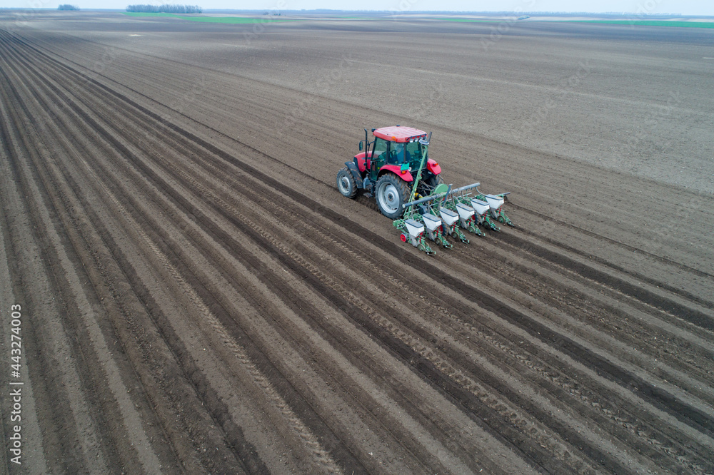 Tractor sowing field shoot from drone
