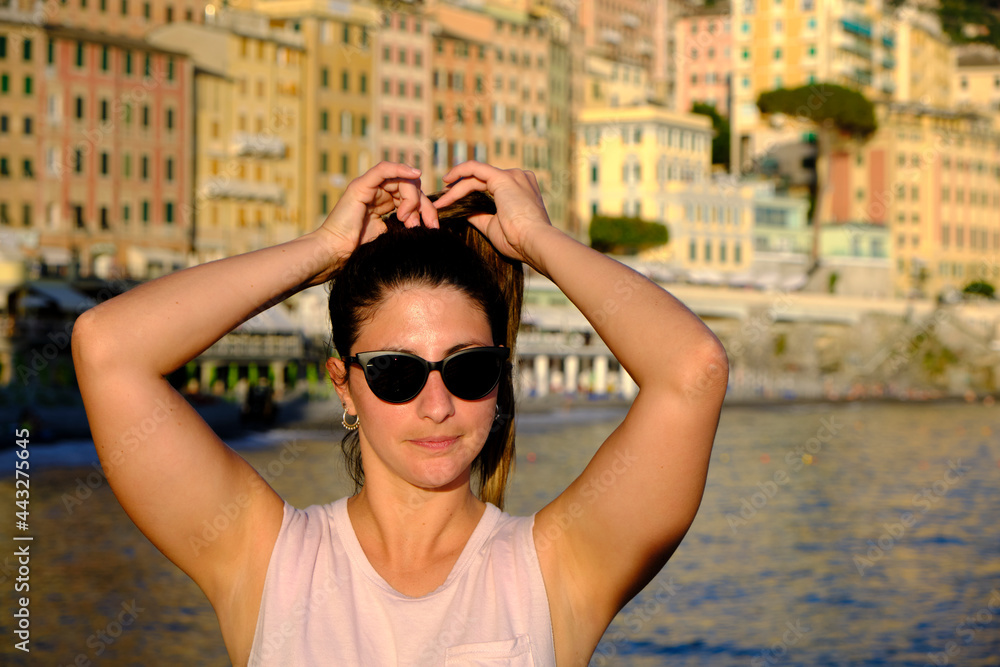 young model wearing sunglasses in the coast of camogli