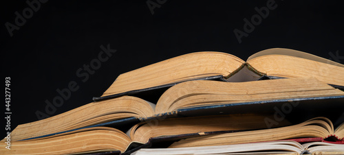 Canvas Print Opened Book on a pile of old books, panorma