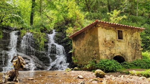 Water mill in PR AS 137 trail between Valbucar and Busllaz villages, also known as 'Molinos del profundu', Villaviciosa, Asturias, Spain photo