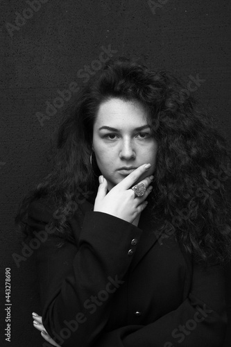 Emotional portraits of a beautiful and curly girl in a jacket