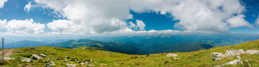 mountain panorama on a sunny day. beautiful nature background. gorgeous cloudscape above the mountain ridge with grassy meadows. travel back country concept