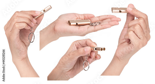 Collection of hand holding Metal Whistle Keychain Key Ring isolated on white background.